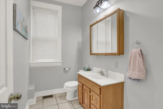 a bathroom with a sink toilet and mirror