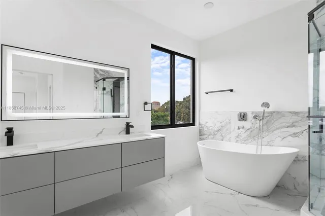a bathroom with a bathtub and shower