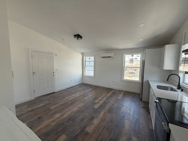 a view of a room with window and wooden floor