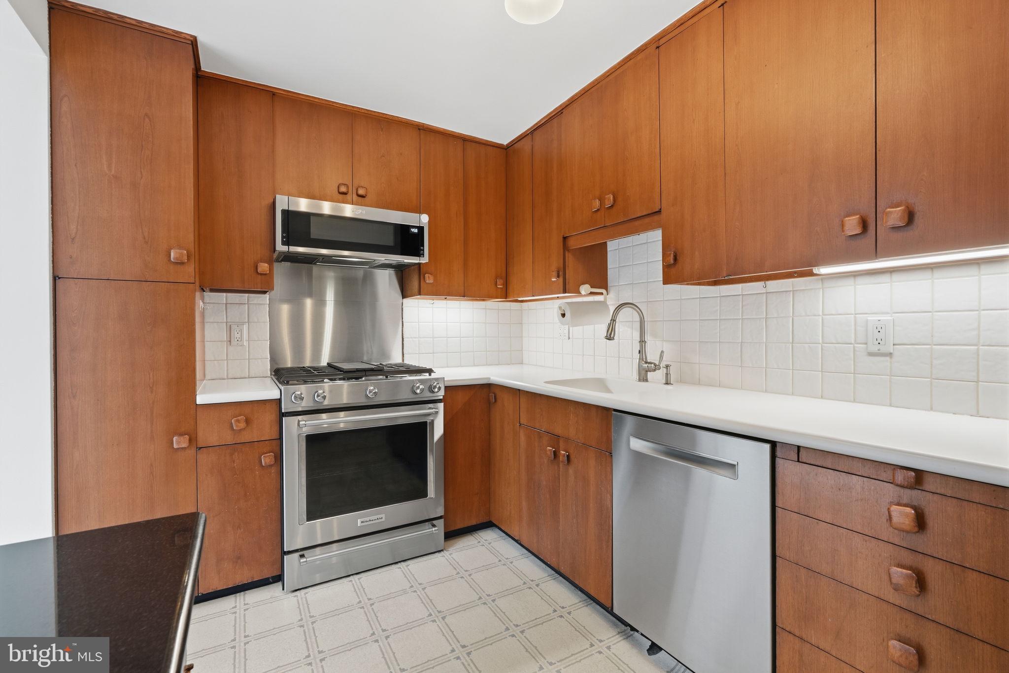 404 Old Farm Road Wyncote, PA 19095 - Photo 12 of 41 Modern kitchen with warm wood tones.