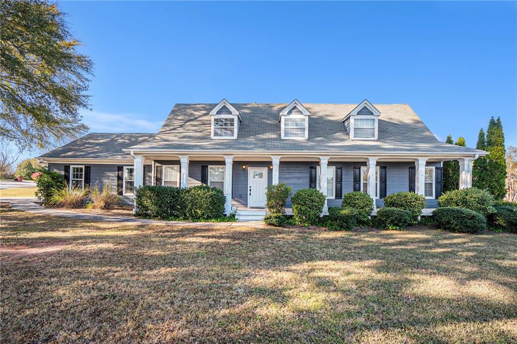 a front view of a residential houses with yard