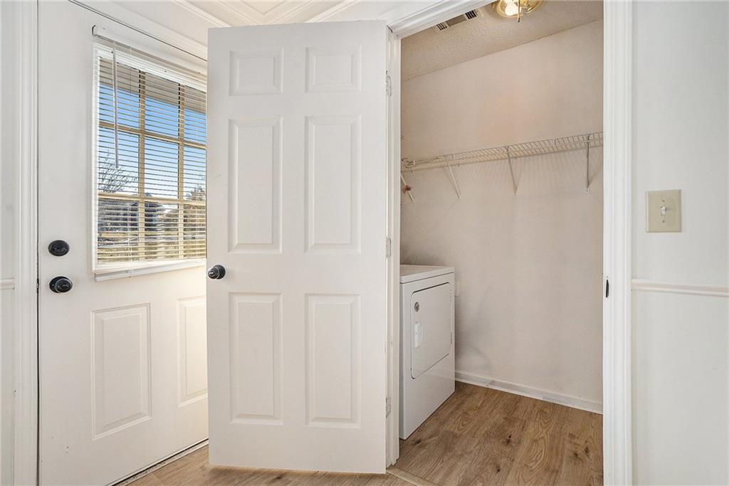 2000 Sage Court Loganville, GA 30052 - Photo 13 of 35 a view of an empty room with wooden floor and a window