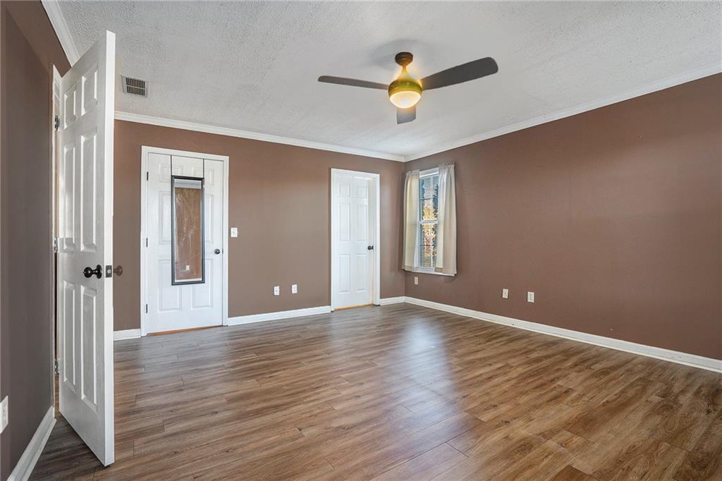 2000 Sage Court Loganville, GA 30052 - Photo 16 of 35 a view of an empty room with wooden floor and a window