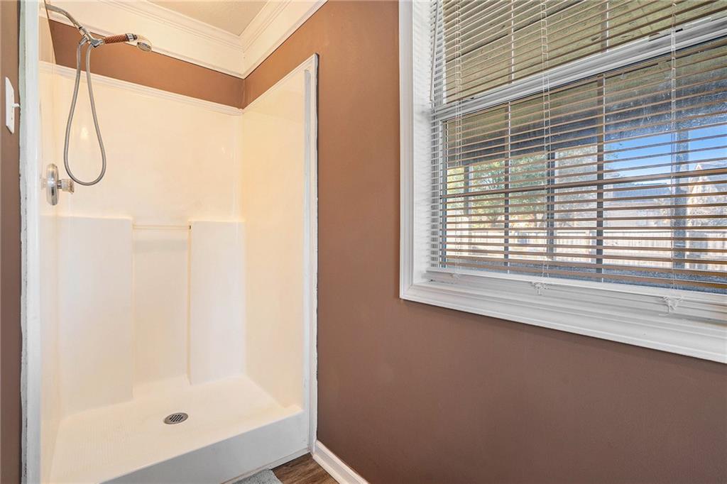2000 Sage Court Loganville, GA 30052 - Photo 19 of 35 a bathroom with a glass shower door