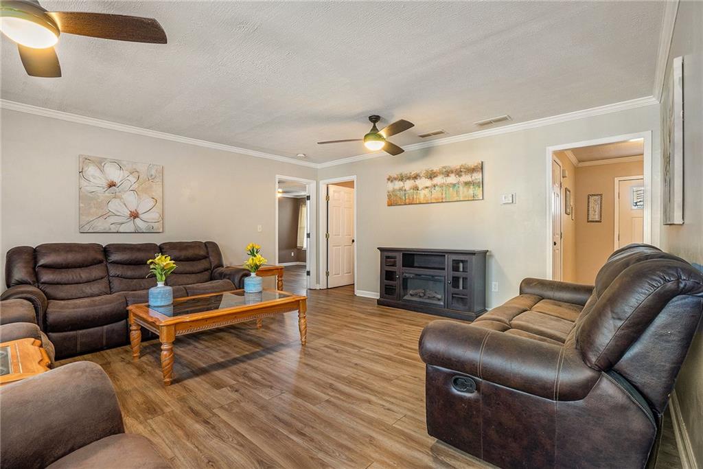 2000 Sage Court Loganville, GA 30052 - Photo 2 of 35 a living room with furniture a fireplace and a flat screen tv