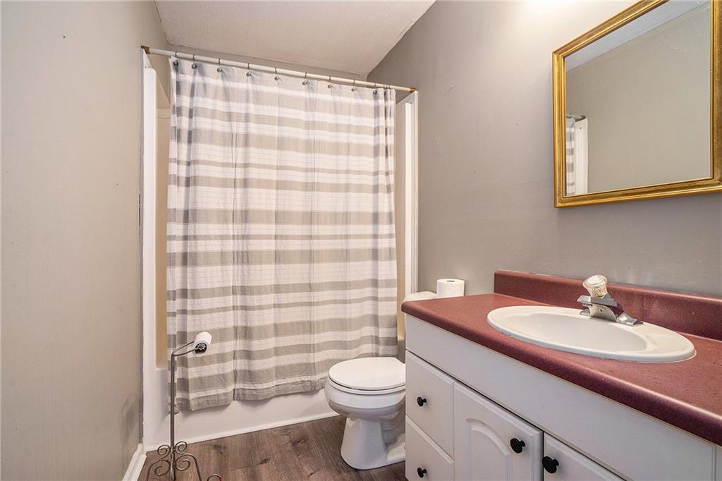 2000 Sage Court Loganville, GA 30052 - Photo 26 of 35 a bathroom with a sink a toilet and shower curtain