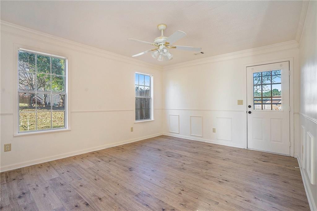 2000 Sage Court Loganville, GA 30052 - Photo 28 of 35 a view of an empty room with wooden floor and a window