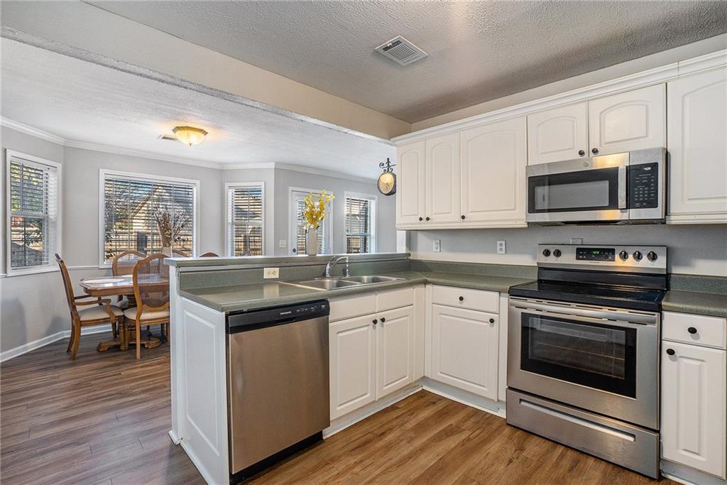 2000 Sage Court Loganville, GA 30052 - Photo 3 of 35 a kitchen with a sink stove and microwave