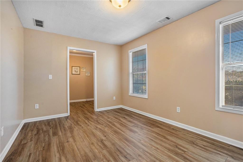 2000 Sage Court Loganville, GA 30052 - Photo 8 of 35 a view of an empty room with wooden floor and a window