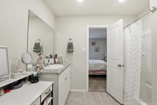a en suite bathroom with a double vanity sink and a mirror