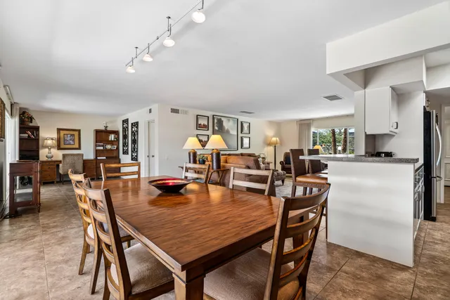 a dining room with furniture and wooden floor