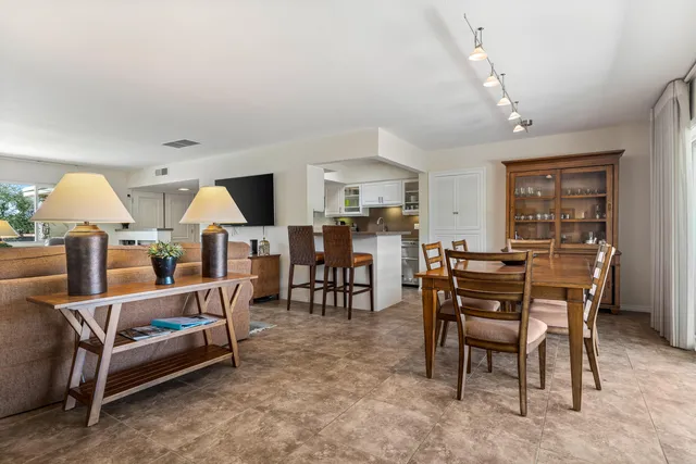 a living room with furniture and a dining table