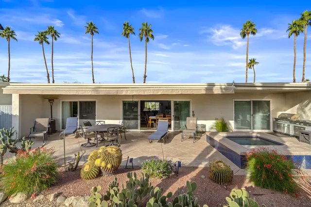 a view of a patio with table and chairs potted plants