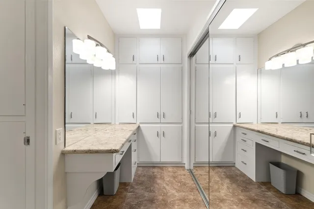 a view of kitchen with granite countertop cabinets and sink