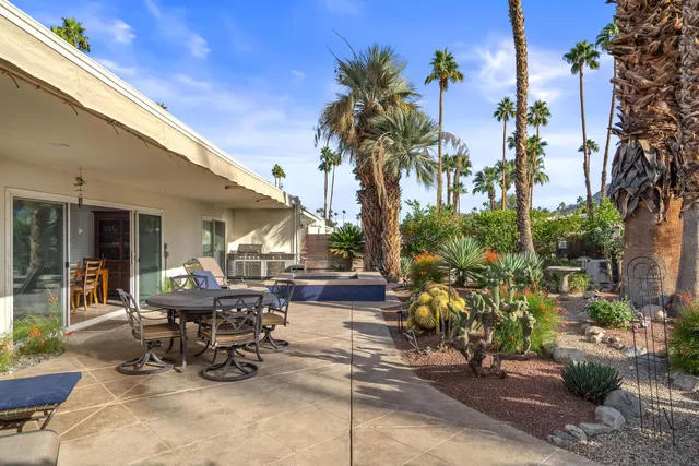 a view of a patio with table and chairs and potted plants