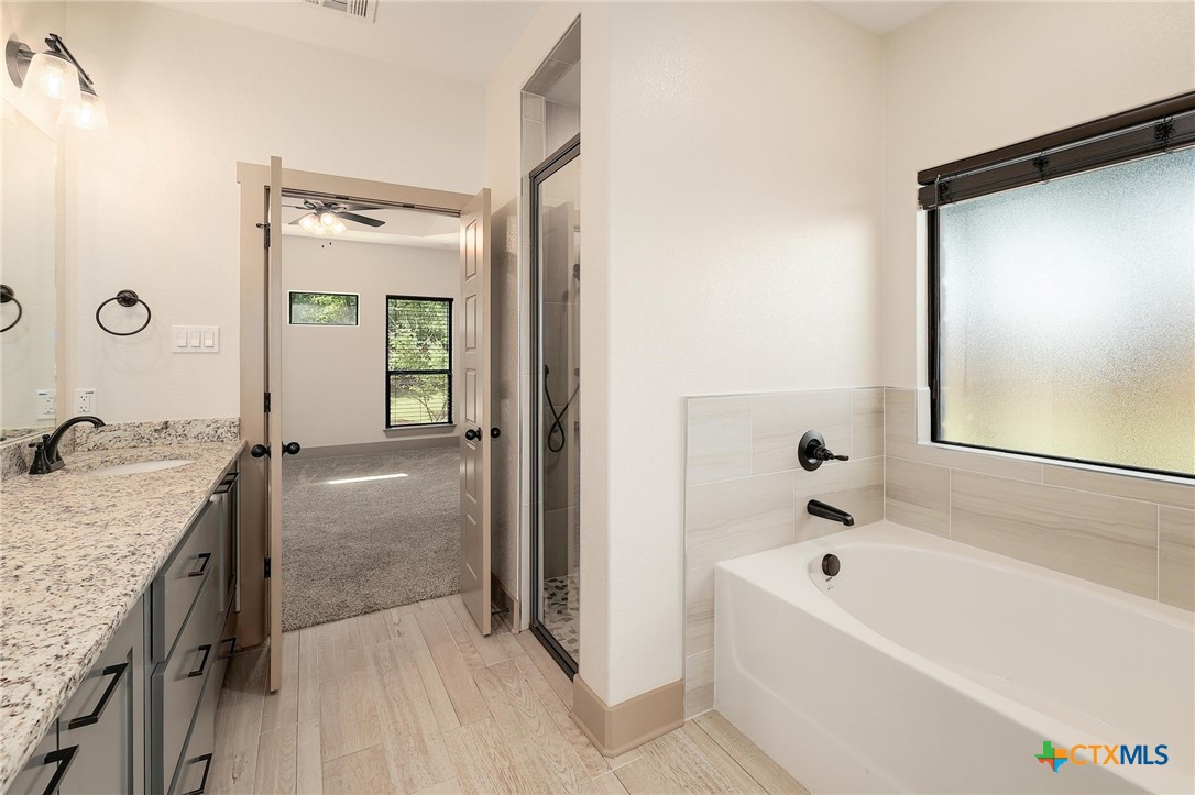 2892 Beulah Boulevard Belton, TX 76513 - Photo 17 of 39 a bathroom with a tub sink and mirror