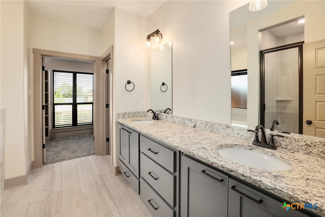 2892 Beulah Boulevard Belton, TX 76513 - Photo 18 of 39 a bathroom with a granite countertop sink mirror and double