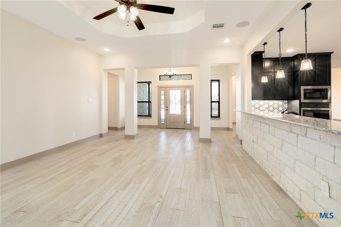 2892 Beulah Boulevard Belton, TX 76513 - Photo 9 of 39 a view of a kitchen with a sink and dishwasher a refrigerator with wooden floor
