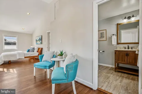 a living room with furniture and a fireplace with wine table