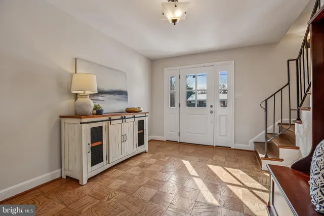 a view of an entryway with wooden floor and door