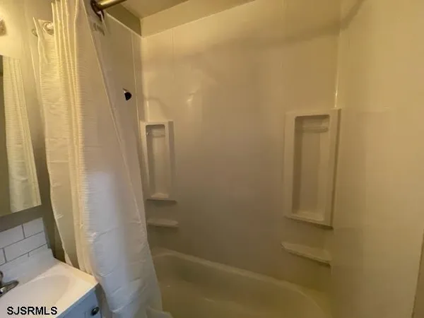 a bathroom with a tub and toilet