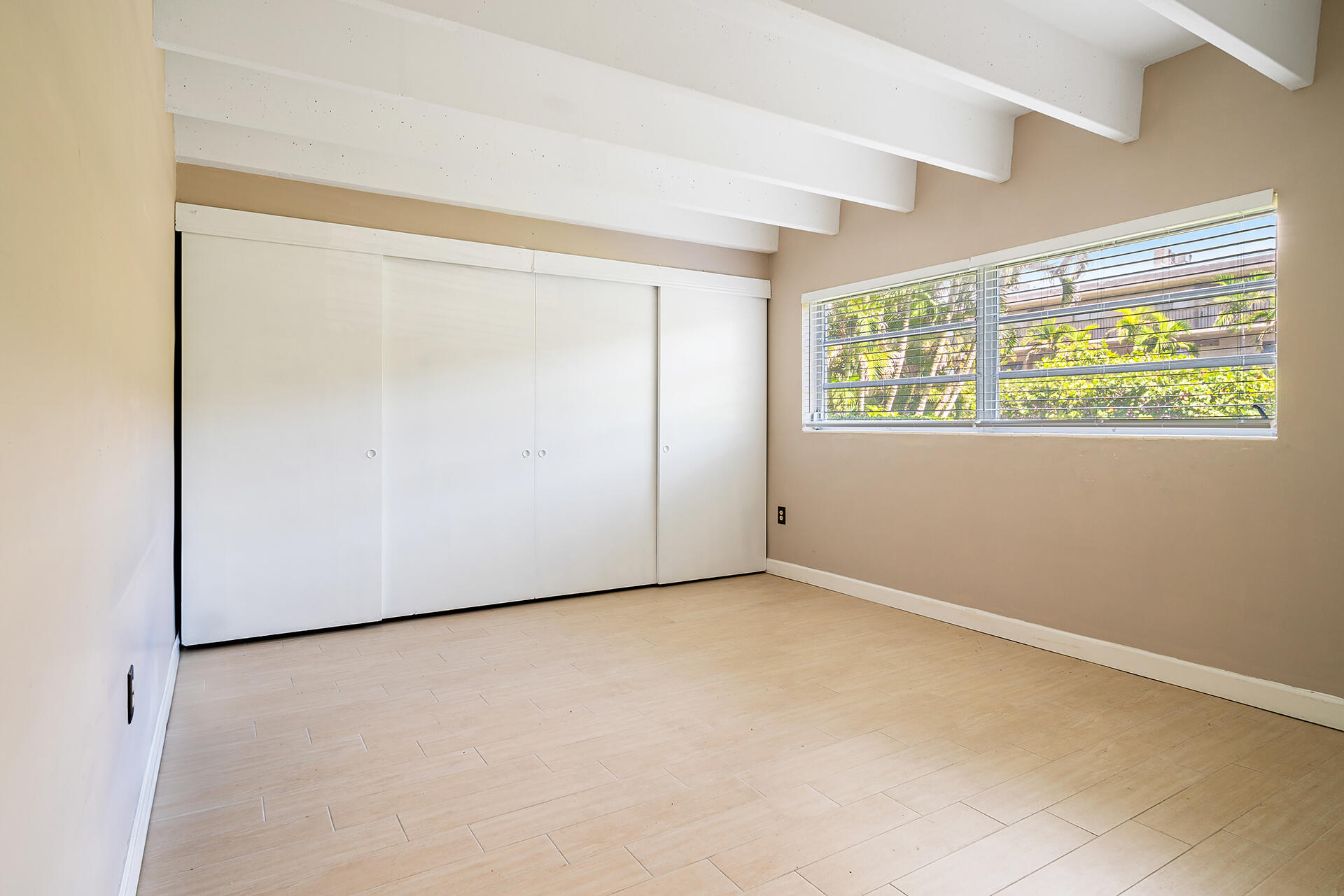 4001 South Ocean Boulevard, Unit 115 South Palm Beach, FL 33480 - Photo 12 of 25 an empty room with windows