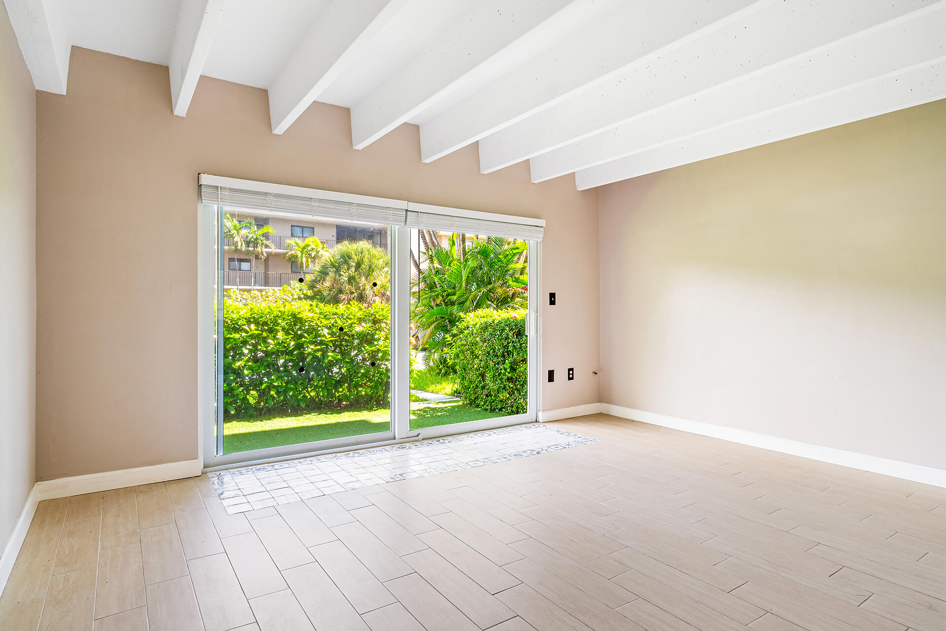 4001 South Ocean Boulevard, Unit 115 South Palm Beach, FL 33480 - Photo 6 of 25 a view of a big room with wooden floor and garden