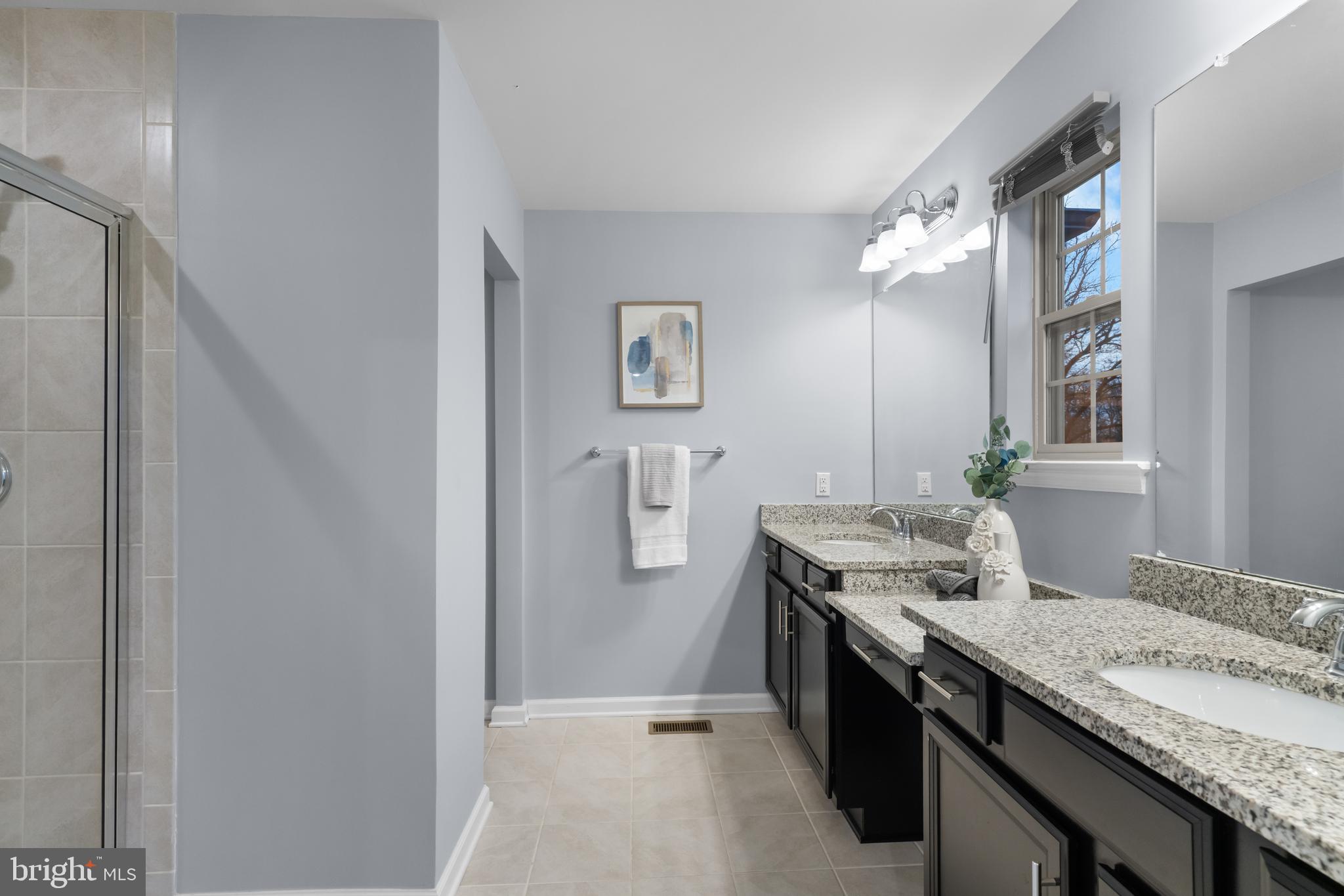 494 Rowan Street Warminster, PA 18974 - Photo 23 of 42 a spacious bathroom with a granite countertop sink and a mirror
