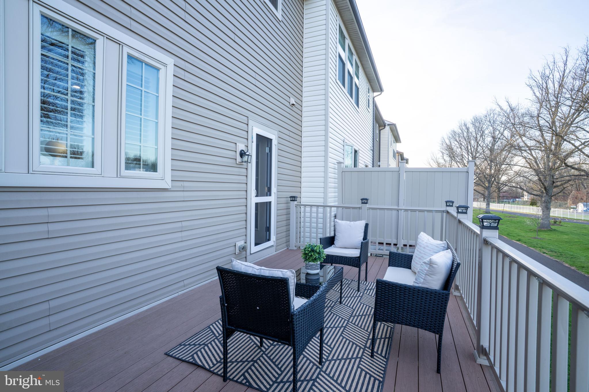 494 Rowan Street Warminster, PA 18974 - Photo 41 of 42 a view of a patio with a dining table and chairs with a deck
