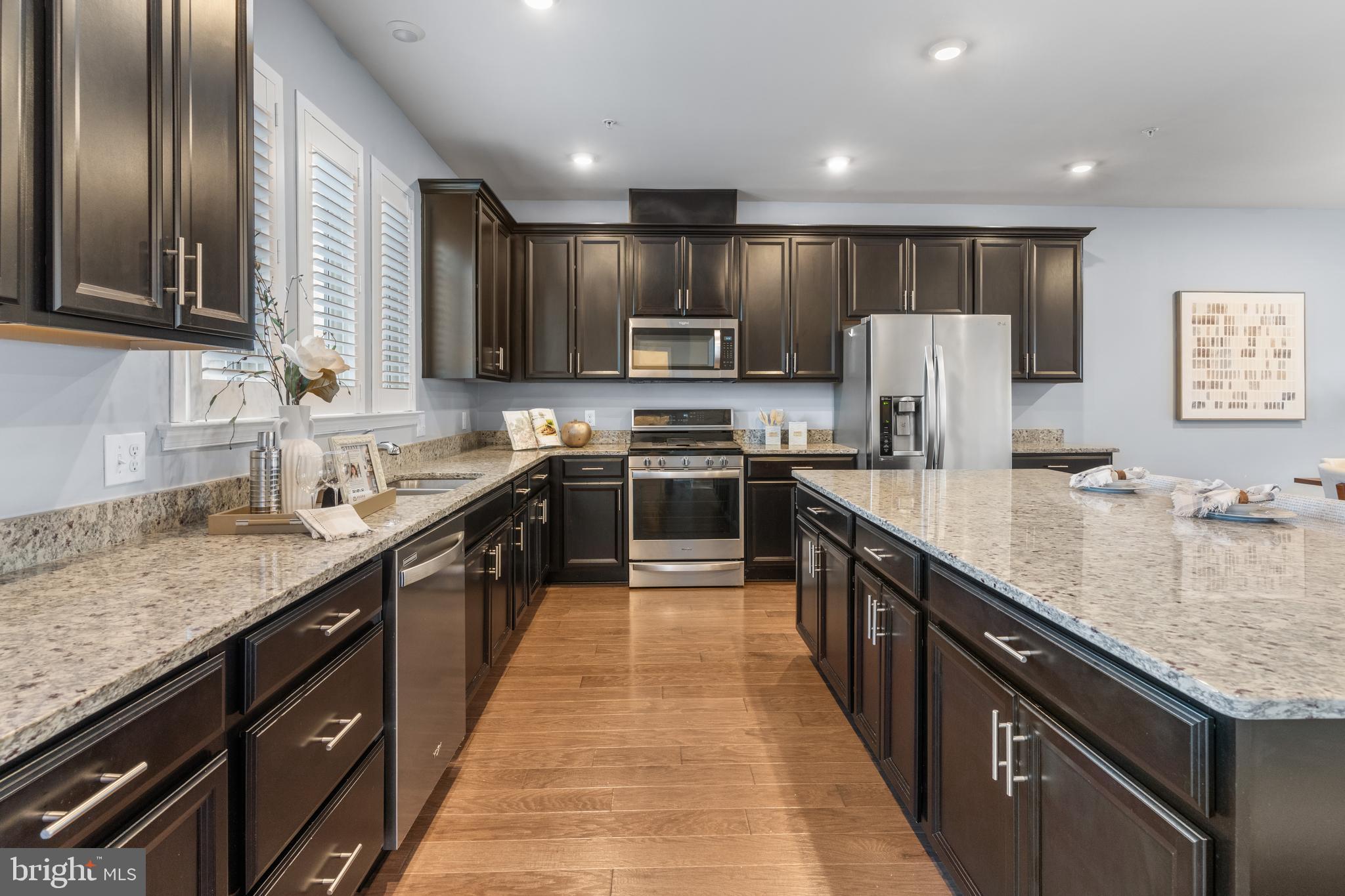 494 Rowan Street Warminster, PA 18974 - Photo 9 of 42 a large kitchen with stainless steel appliances granite countertop a sink counter space cabinets and a large window