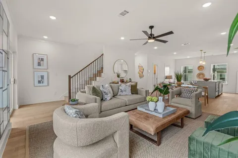 a living room with furniture or couches and a potted plant