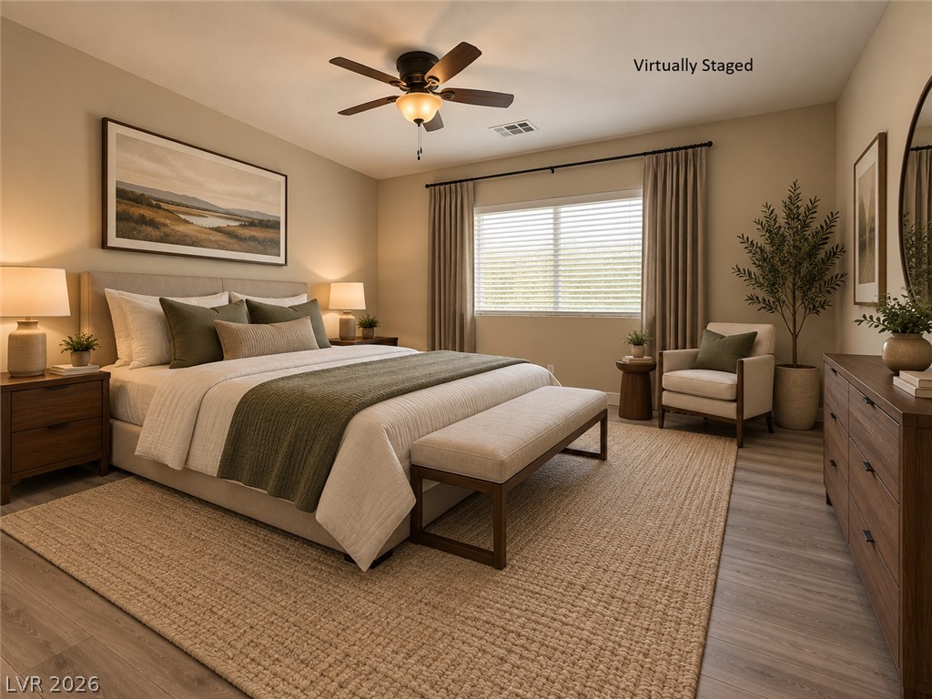 8059 Encanterra Road Las Vegas, NV 89113 - Photo 22 of 52 Smooth wood flooring and a wide window with integrated blinds frame this restful bedroom space.