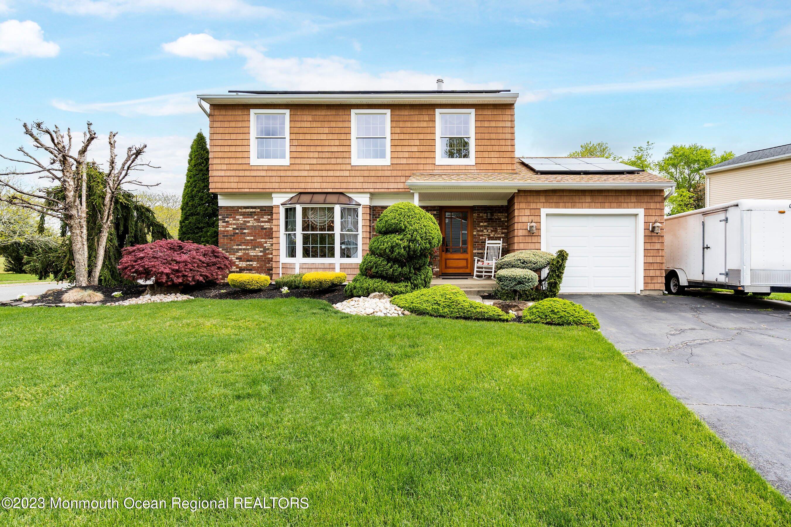 a front view of house with yard and green space