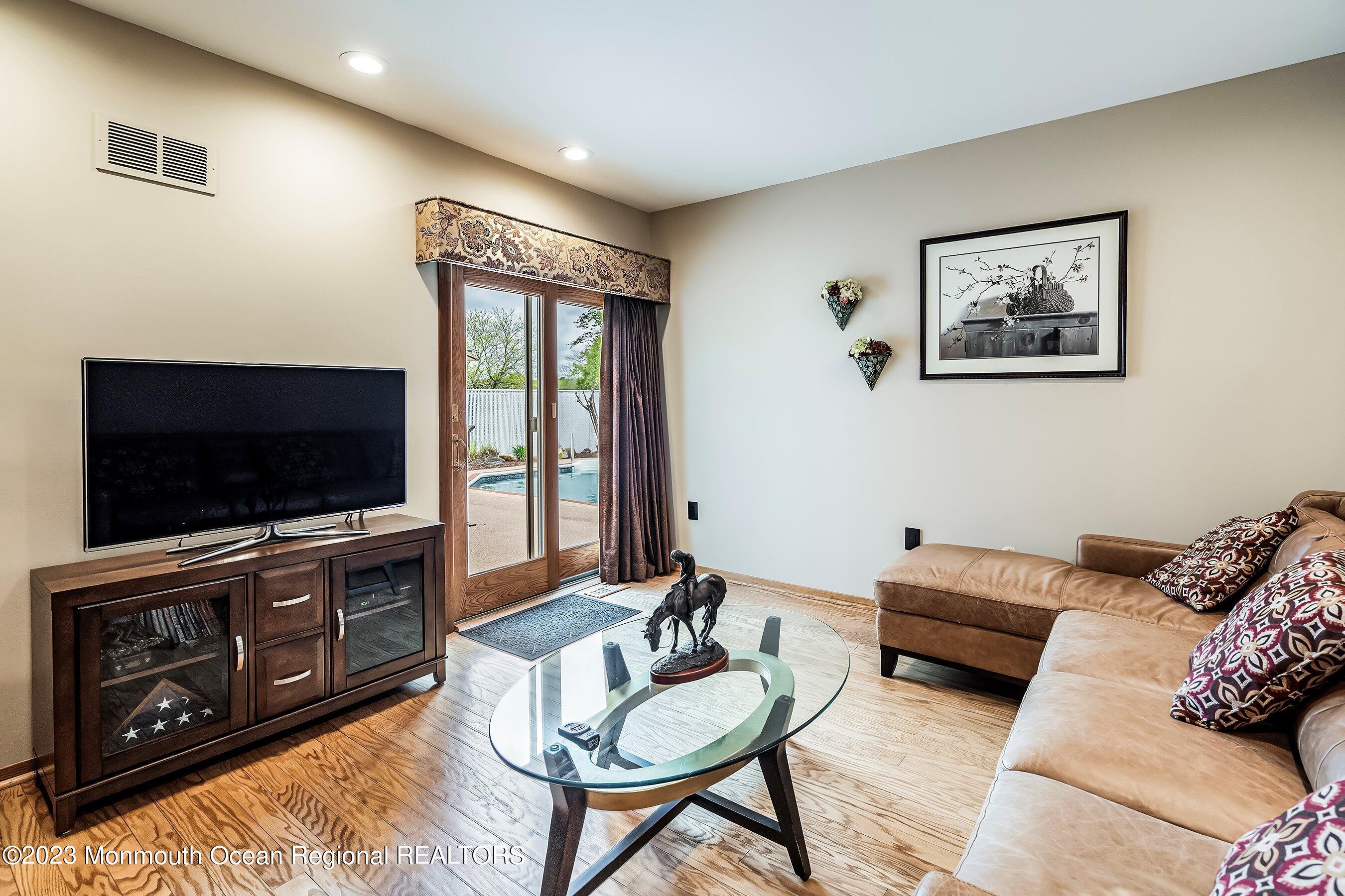 1 Hearth Court Howell, NJ 07731 - Photo 11 of 23 a living room with furniture and a flat screen tv