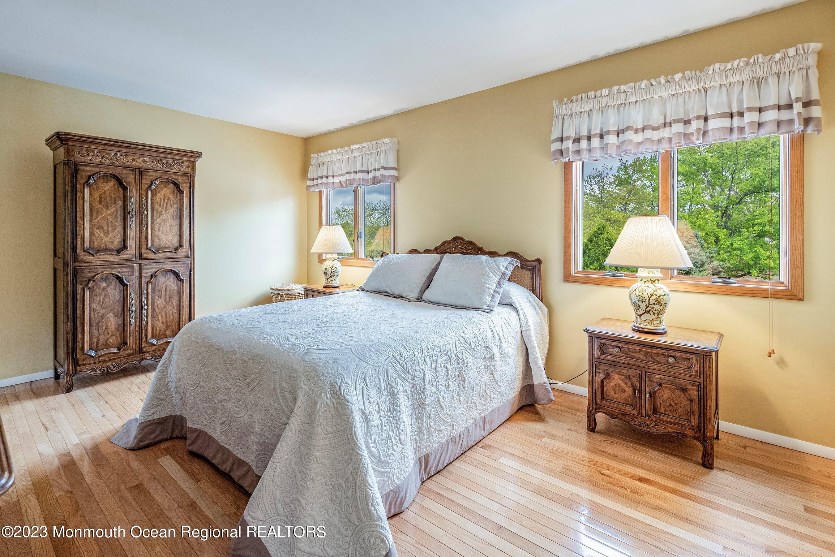 1 Hearth Court Howell, NJ 07731 - Photo 16 of 23 a bedroom with a bed and a dresser next to a window
