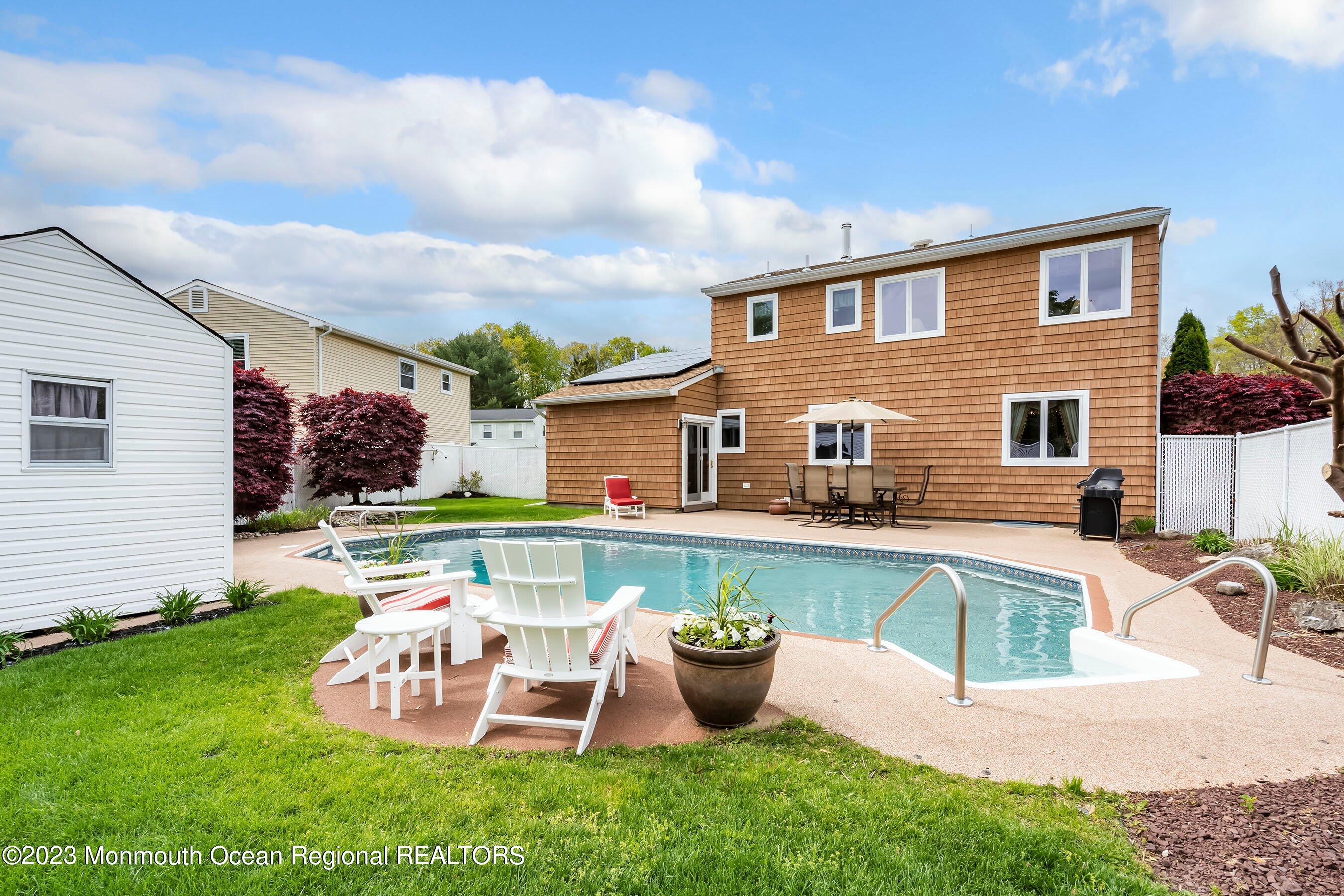 1 Hearth Court Howell, NJ 07731 - Photo 23 of 23 a view of a house with backyard sitting area and swimming pool