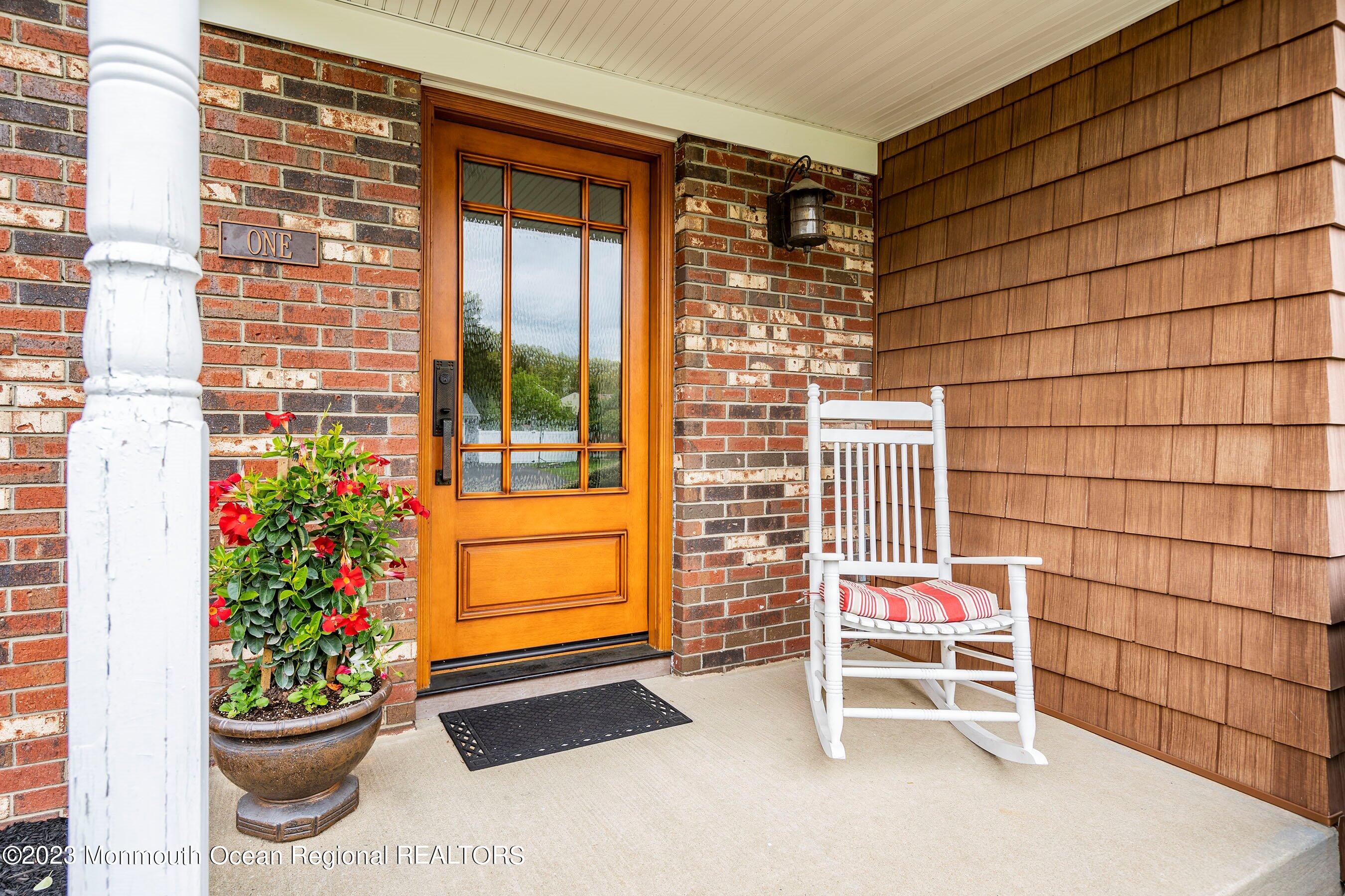 1 Hearth Court Howell, NJ 07731 - Photo 3 of 23 a balcony with a potted plant and a chair