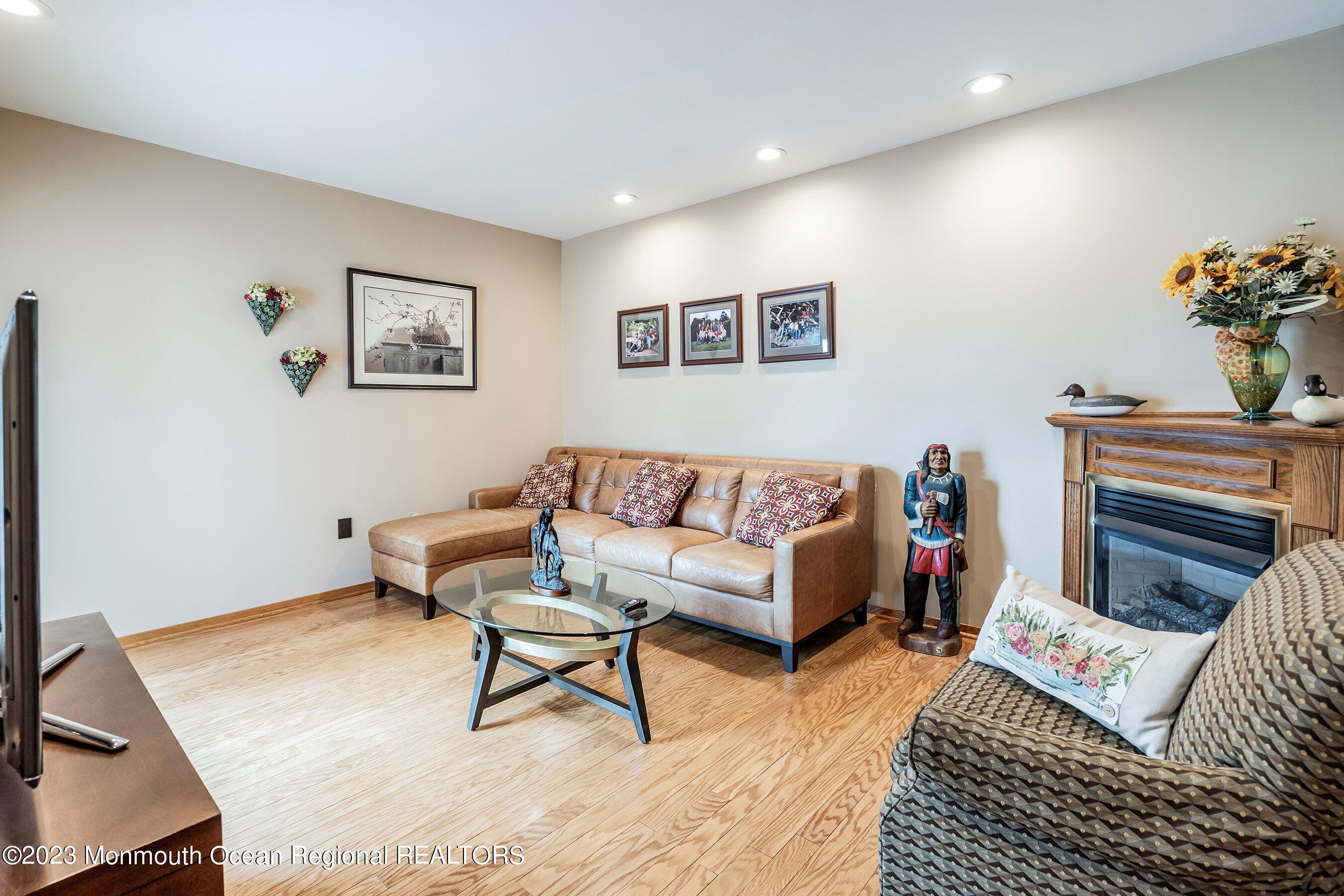 1 Hearth Court Howell, NJ 07731 - Photo 10 of 23 a living room with furniture and a fireplace
