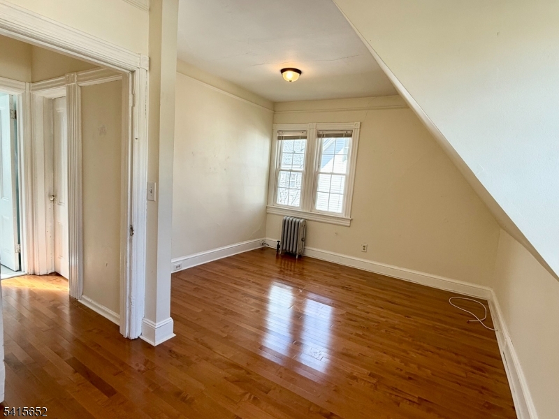 8 William Street Summit, NJ 07901 - Photo 13 of 17 an empty room with wooden floor and windows