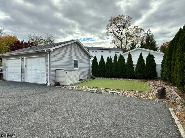 a view of house with outdoor space and parking