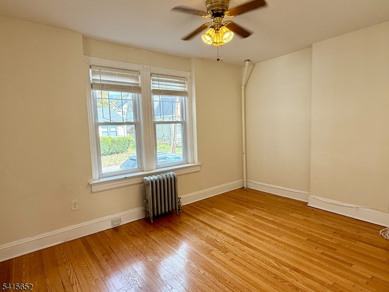 8 William Street Summit, NJ 07901 - Photo 8 of 17 a view of an empty room with a window and wooden floor