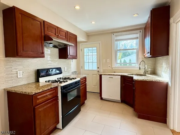 a kitchen with stainless steel appliances granite countertop a stove sink and microwave