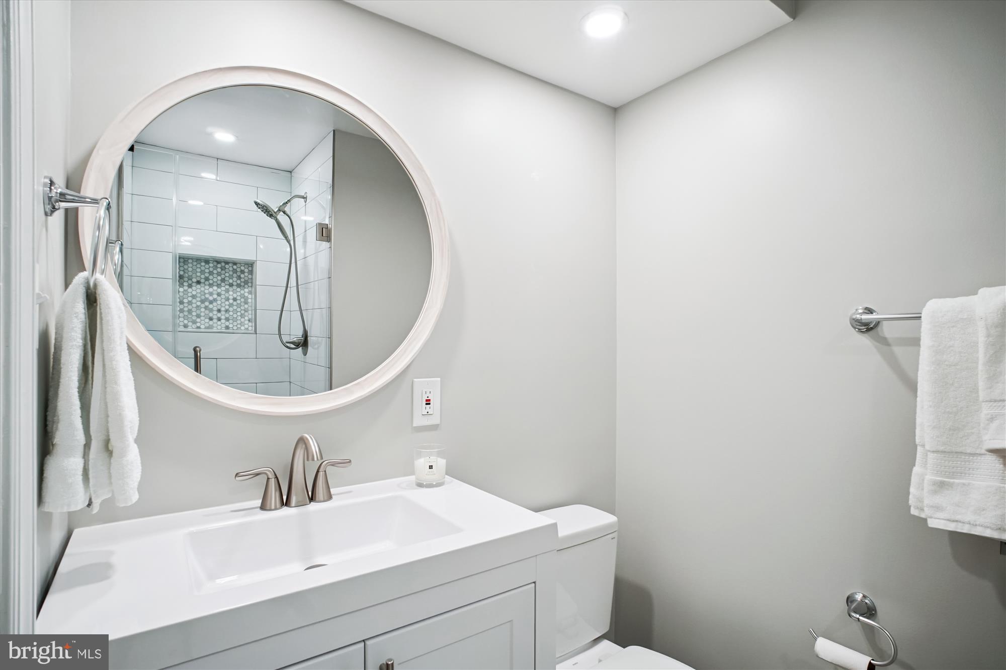 6709 Fairfax Road, Unit 72 Chevy Chase, MD 20815 - Photo 16 of 37 a bathroom with a sink and a mirror