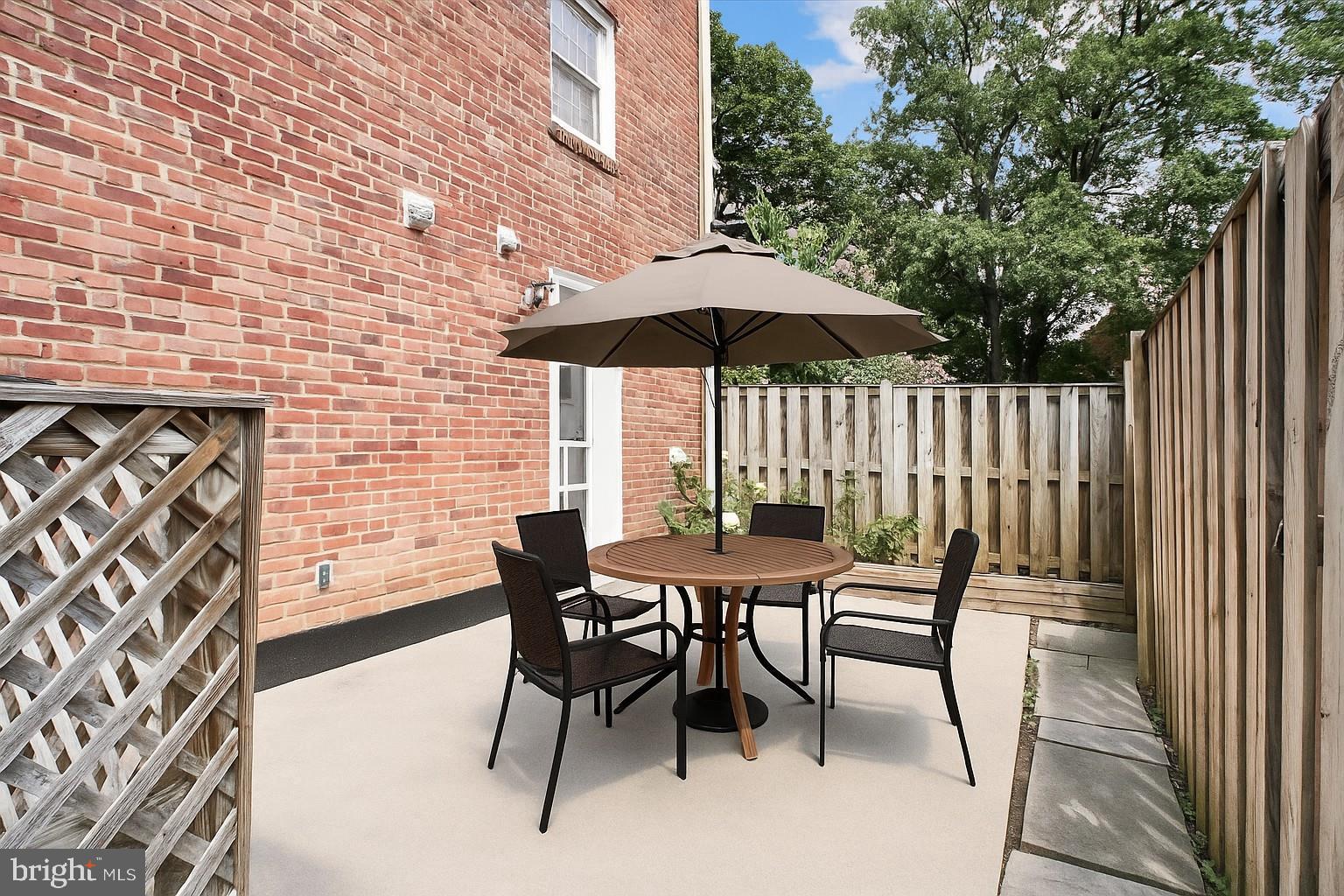 6709 Fairfax Road, Unit 72 Chevy Chase, MD 20815 - Photo 2 of 37 an outdoor space with furniture and umbrella