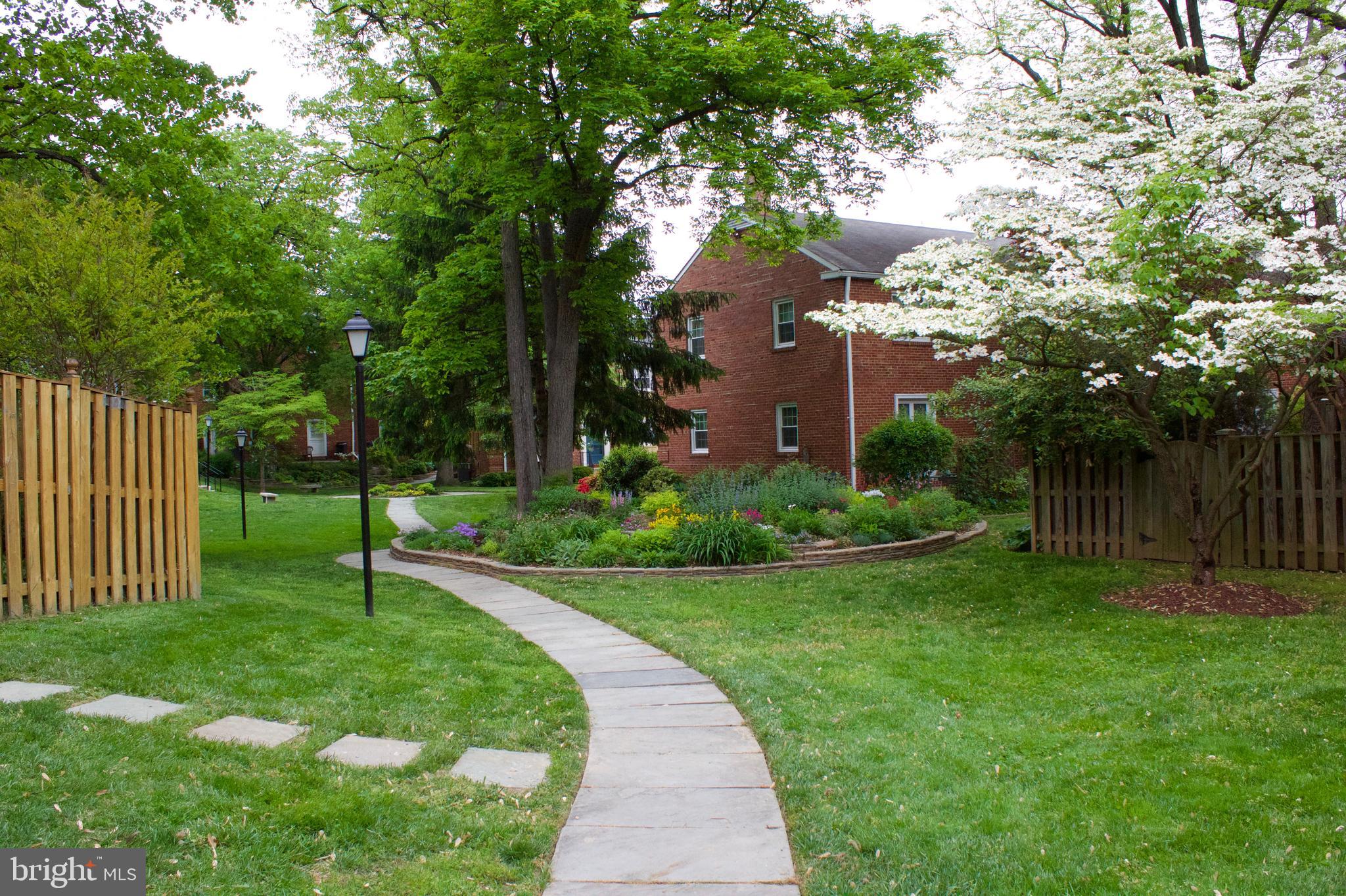 6709 Fairfax Road, Unit 72 Chevy Chase, MD 20815 - Photo 23 of 37 a view of a pathway with a house in the background