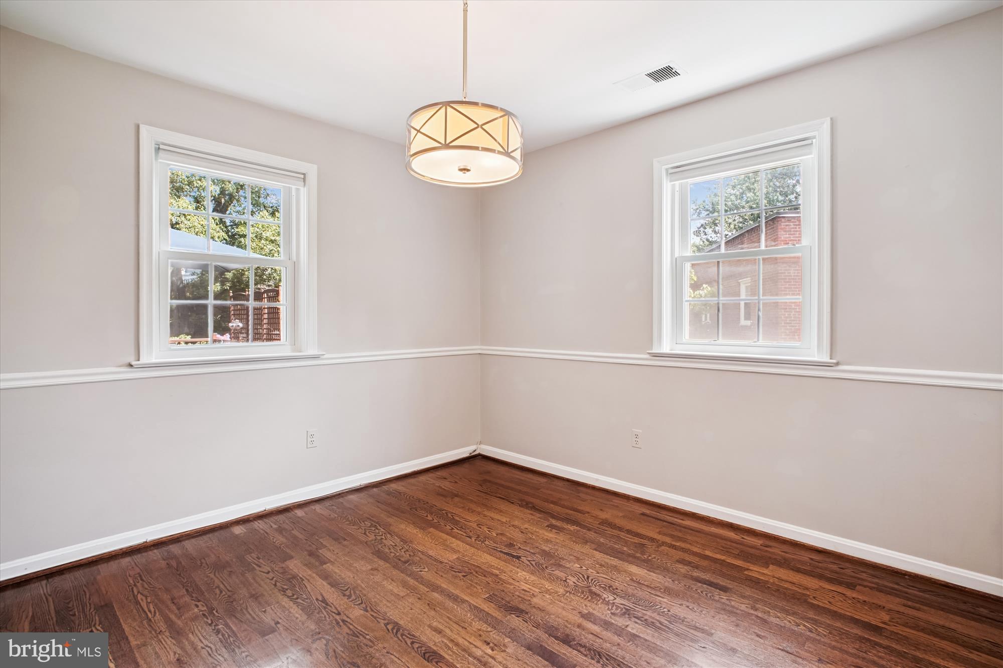 6709 Fairfax Road, Unit 72 Chevy Chase, MD 20815 - Photo 6 of 37 wooden floor in an empty room with a window
