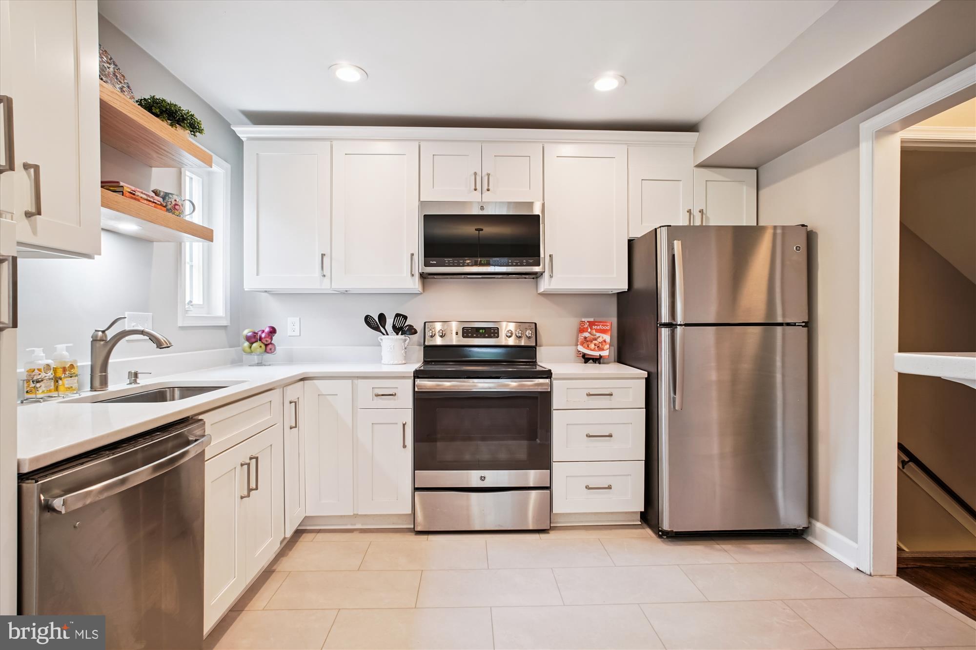 6709 Fairfax Road, Unit 72 Chevy Chase, MD 20815 - Photo 7 of 37 a kitchen with stainless steel appliances a refrigerator stove and sink