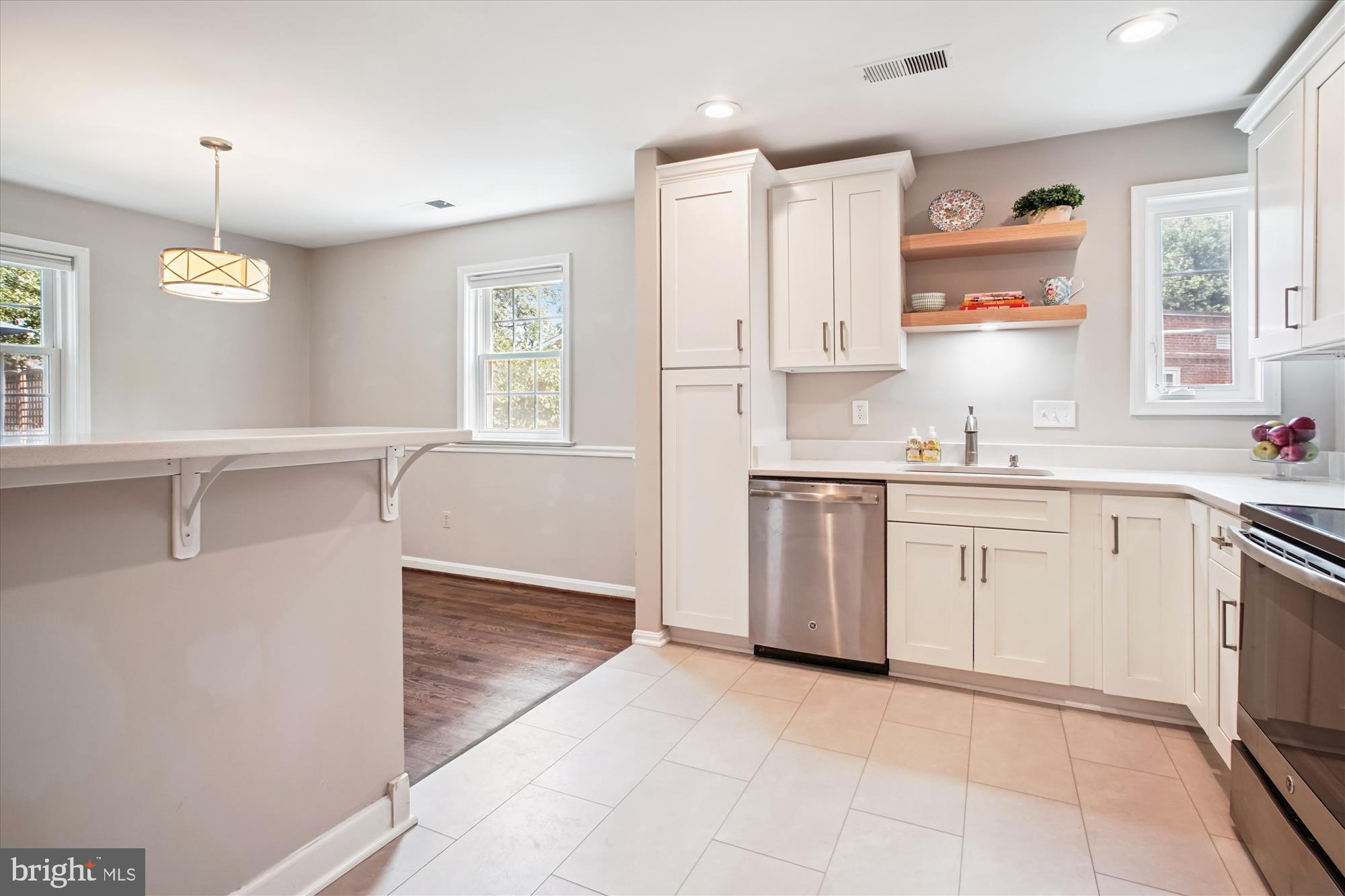 6709 Fairfax Road, Unit 72 Chevy Chase, MD 20815 - Photo 8 of 37 a kitchen with a stove a sink and a window