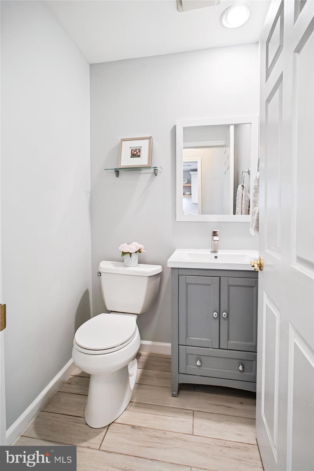 6709 Fairfax Road, Unit 72 Chevy Chase, MD 20815 - Photo 9 of 37 a bathroom with a sink toilet and vanity