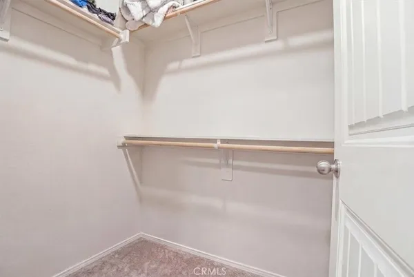 a bathroom with a sink a toilet a mirror and shower curtain